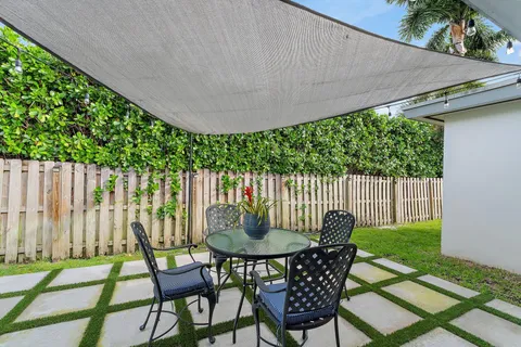 a patio with table and chairs