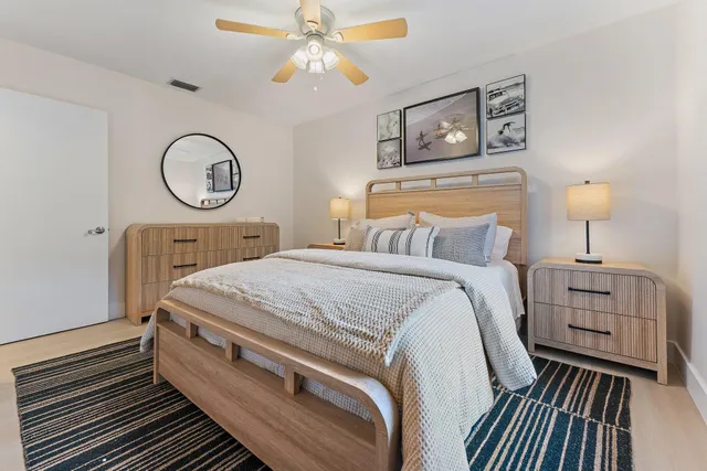 a spacious bedroom with a bed and a chandelier