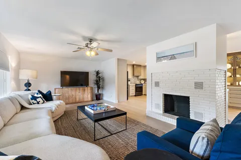 a living room with furniture fireplace and a flat screen tv