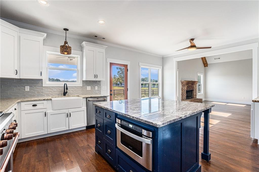1550 Knox Chapel Road Social Circle, GA 30025 - Photo 14 of 35 a kitchen with granite countertop a sink cabinets and wooden floor