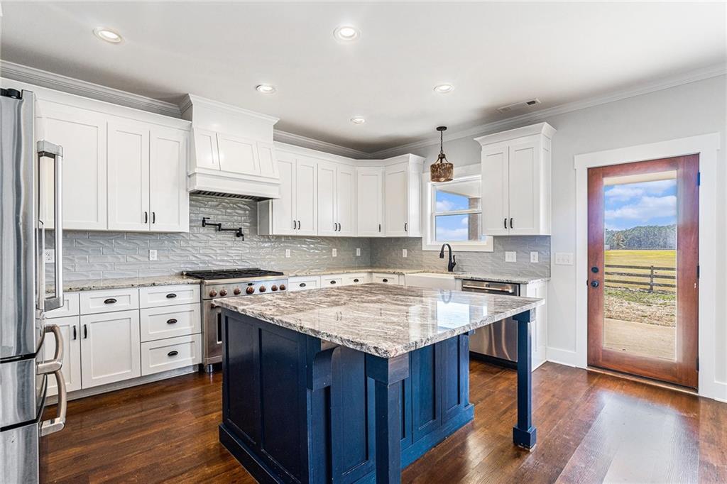 1550 Knox Chapel Road Social Circle, GA 30025 - Photo 15 of 35 a kitchen with a stove top oven sink and cabinets