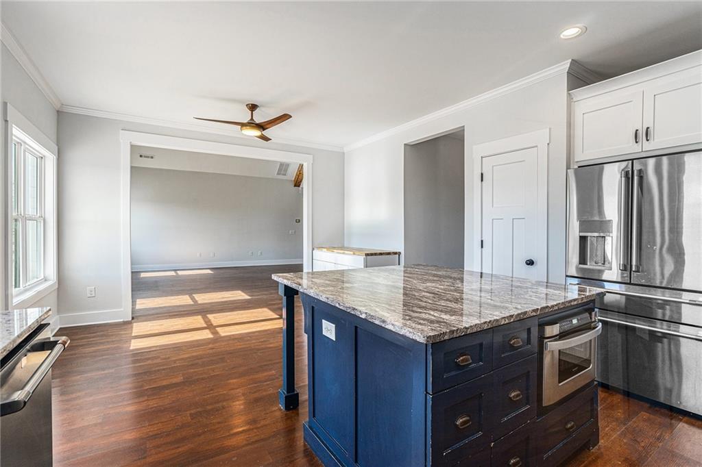 1550 Knox Chapel Road Social Circle, GA 30025 - Photo 16 of 35 a kitchen with stainless steel appliances granite countertop a sink and a refrigerator