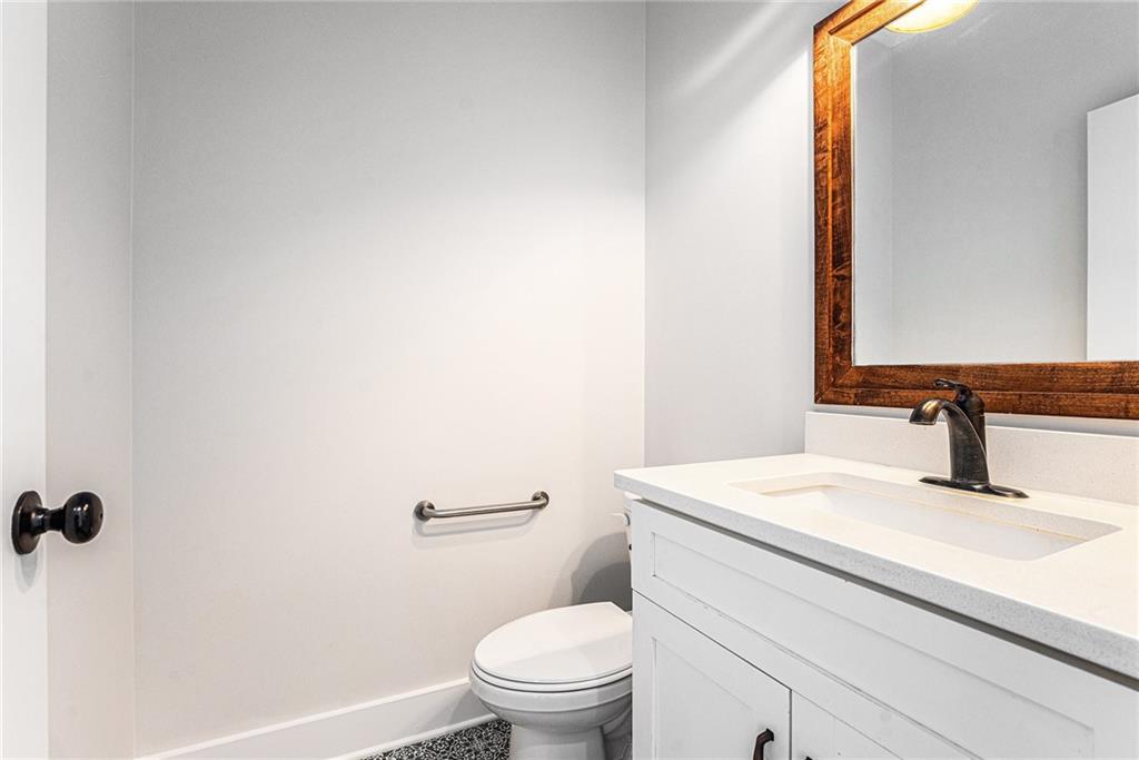 1550 Knox Chapel Road Social Circle, GA 30025 - Photo 19 of 35 a bathroom with a sink a toilet and mirror