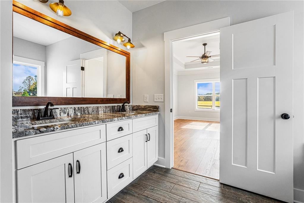1550 Knox Chapel Road Social Circle, GA 30025 - Photo 24 of 35 a bathroom with a granite countertop sink and a mirror