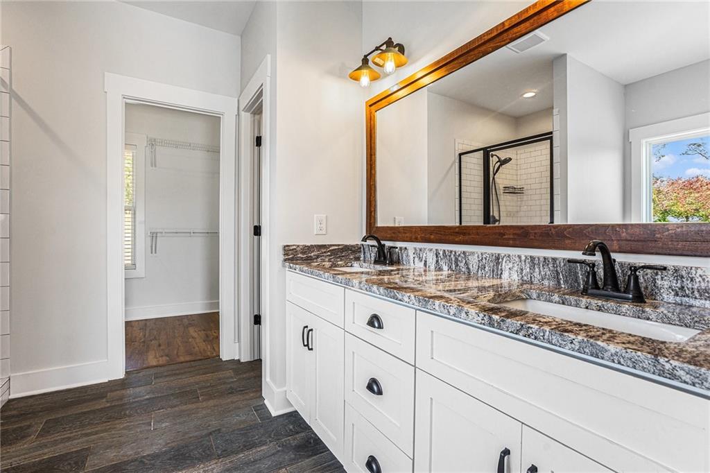 1550 Knox Chapel Road Social Circle, GA 30025 - Photo 25 of 35 a bathroom with a granite countertop sink mirror and vanity