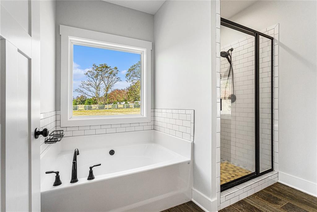 1550 Knox Chapel Road Social Circle, GA 30025 - Photo 26 of 35 a bathroom with a bathtub and a shower