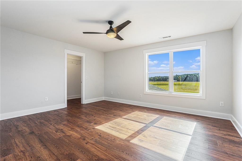 1550 Knox Chapel Road Social Circle, GA 30025 - Photo 27 of 35 a view of an empty room with a window and wooden floor