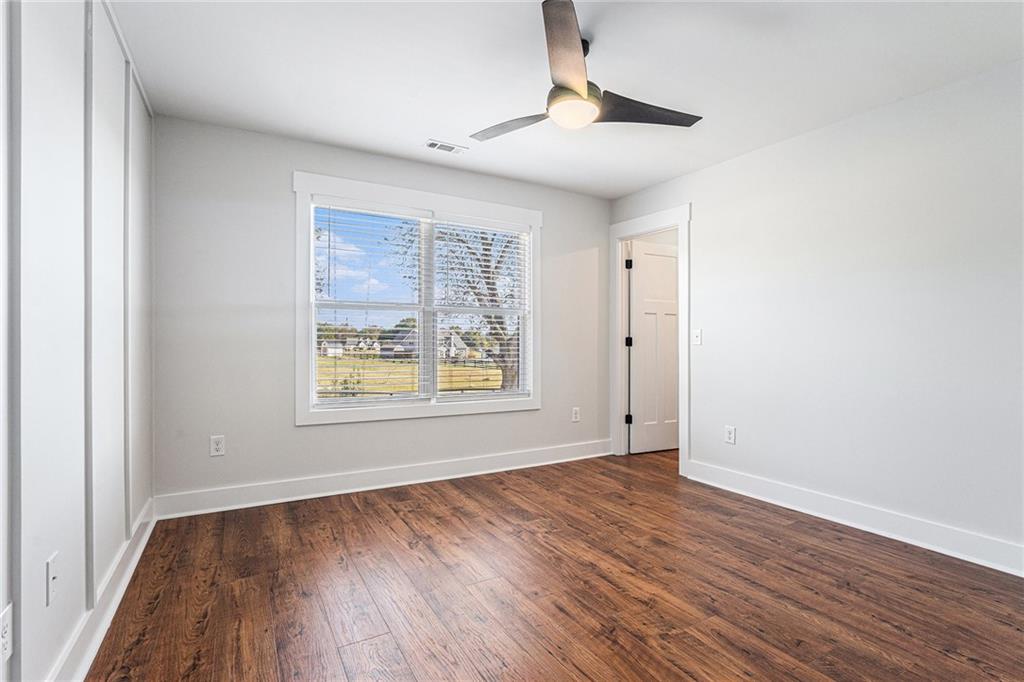 1550 Knox Chapel Road Social Circle, GA 30025 - Photo 28 of 35 a view of an empty room with wooden floor and a window