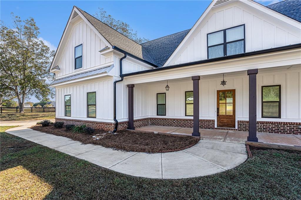 1550 Knox Chapel Road Social Circle, GA 30025 - Photo 3 of 35 a view of a house with backyard porch and wooden fence