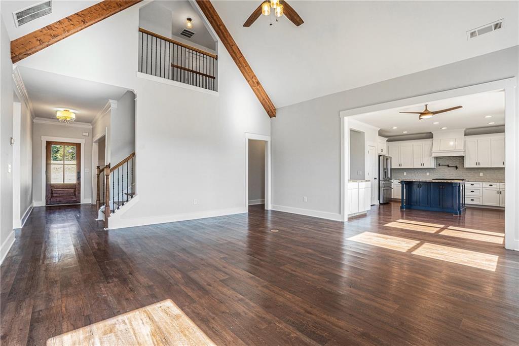 1550 Knox Chapel Road Social Circle, GA 30025 - Photo 5 of 35 an empty room with wooden floor and fireplace