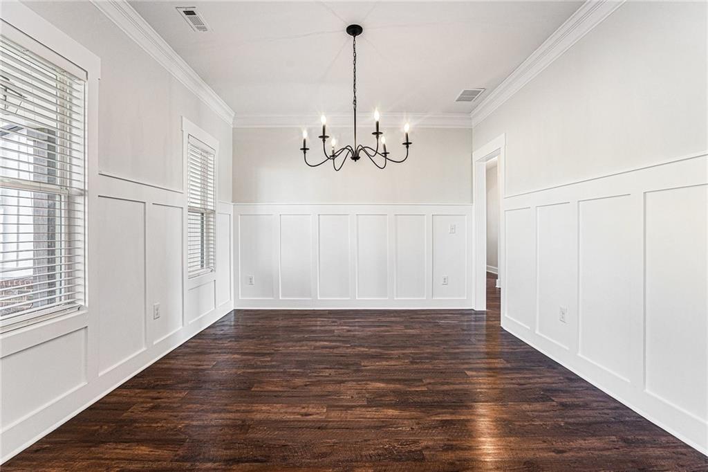 1550 Knox Chapel Road Social Circle, GA 30025 - Photo 10 of 35 a view of a room with wooden floor chandelier and windows