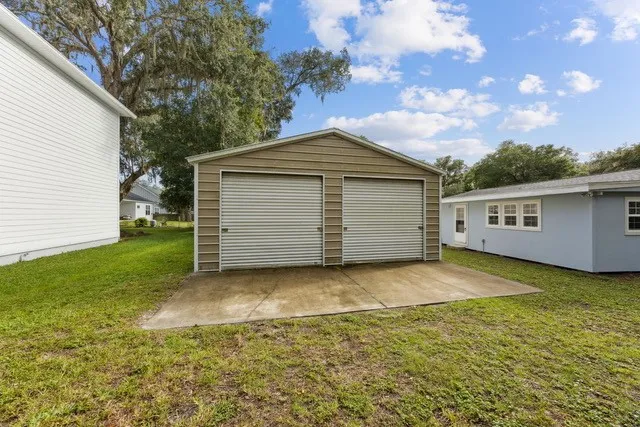 a backyard of a house with yard and garage