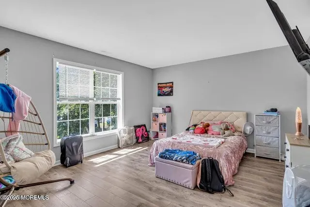 a bedroom with a bed a couch and a window with outer view
