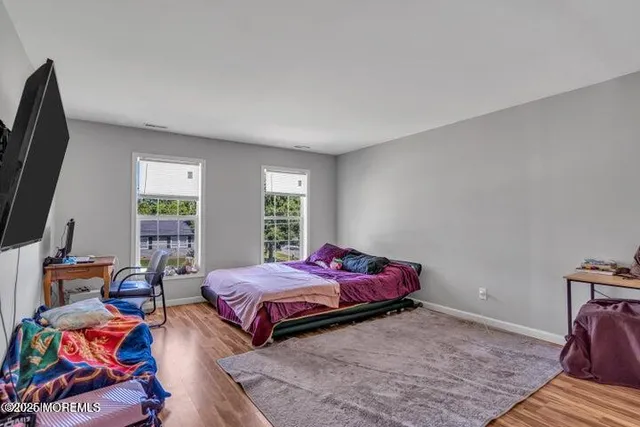 a bedroom with bed and a window