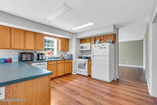 a kitchen with white cabinets and white appliances