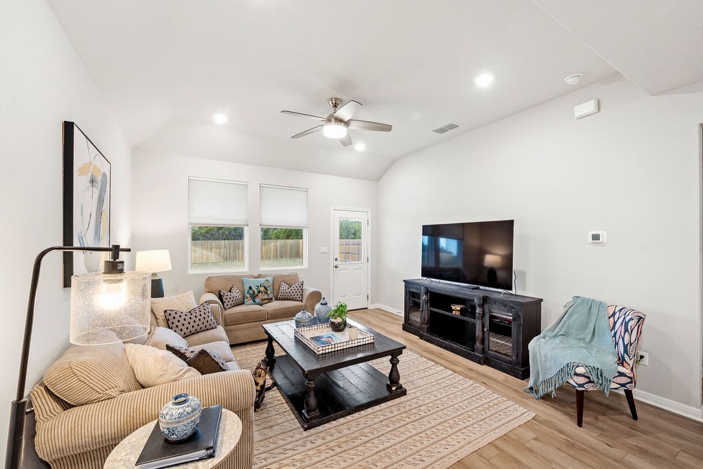 2417 Roosevelt Road Leander, TX 78641 - Photo 7 of 40 Living room with lofted ceiling, light wood-style flooring, a ceiling fan, and recessed lighting