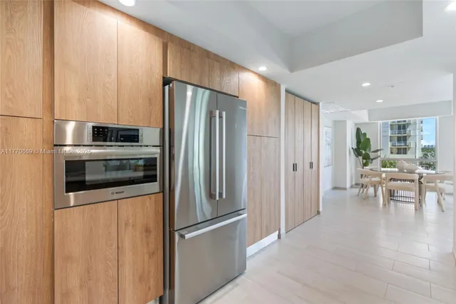 a kitchen with stainless steel appliances a refrigerator and a stove top oven