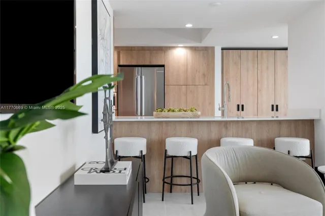 a living room with furniture a flat screen tv and a large window