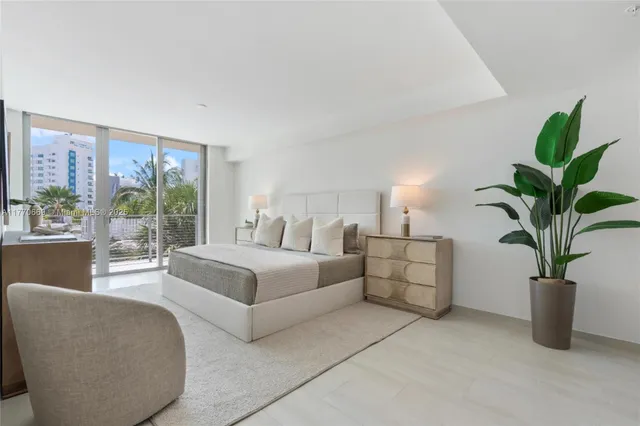 a bedroom with a bed and flat screen tv