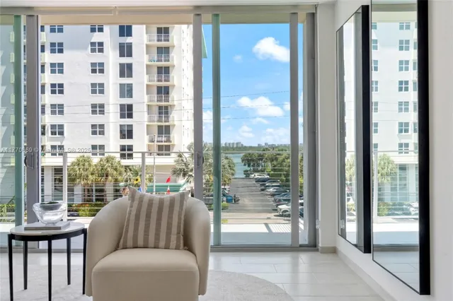 a living room with furniture and a floor to ceiling window