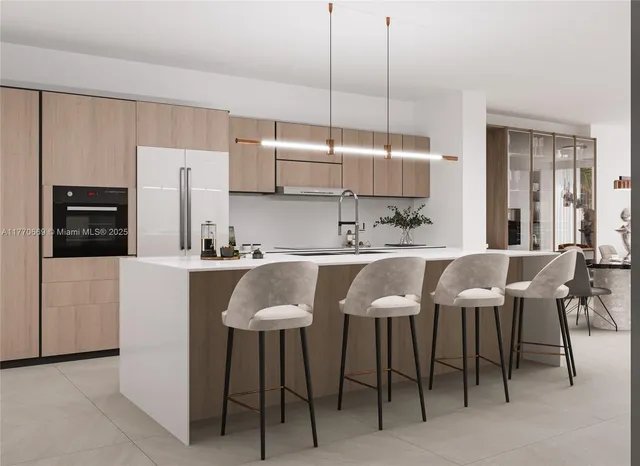 a kitchen with a dining table chairs sink and cabinets