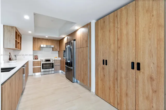 a kitchen with stainless steel appliances a refrigerator and a sink