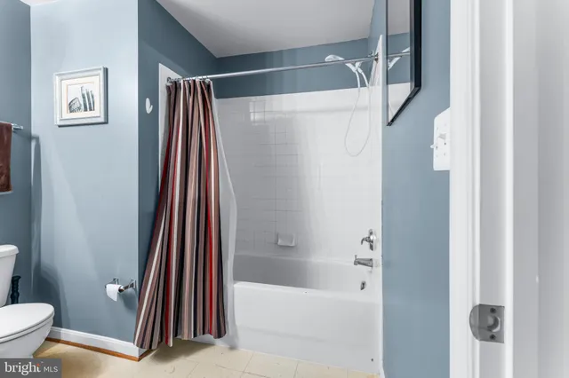 a bathroom with a shower curtain and a sink