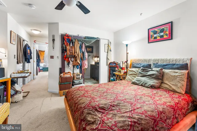 a bedroom with a bed and a large mirror