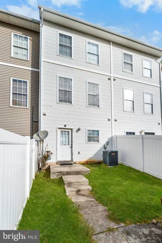 a front view of a house with a garden and yard