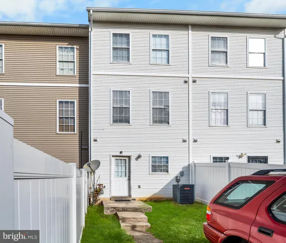 a front view of a house with a garden and yard