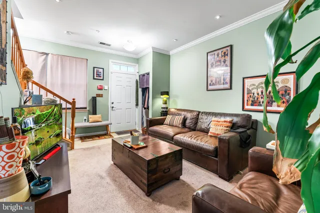 a living room with furniture cabinets and a flat screen tv