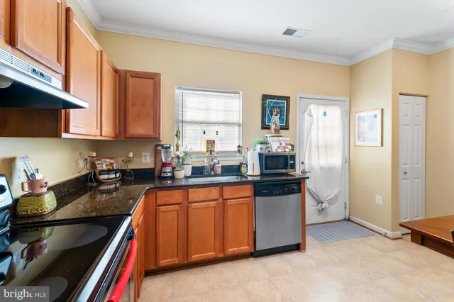 a kitchen with stainless steel appliances a stove a sink and a microwave