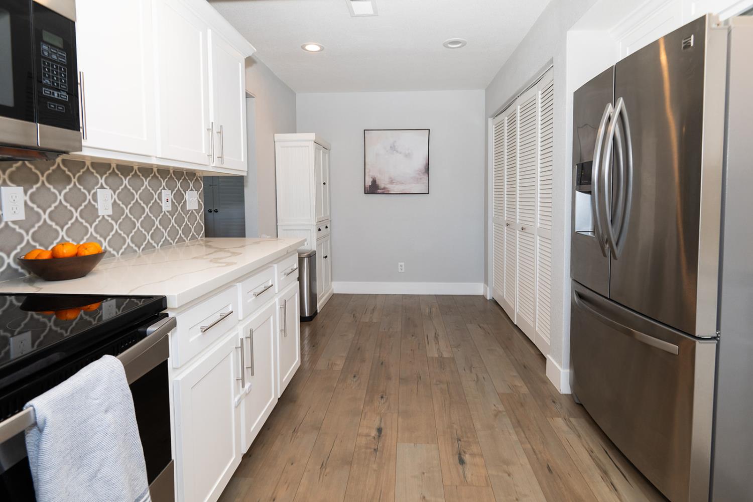 2672 Rio Bravo Circle Sacramento, CA 95826 - Photo 7 of 26 a kitchen with stainless steel appliances a refrigerator a stove and wooden floor