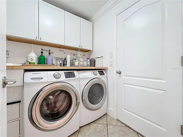 an entryway with a table and chairs