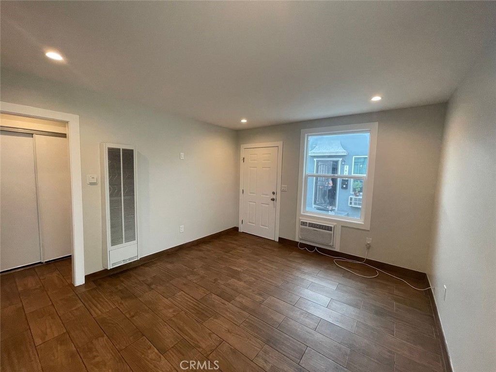 1413 East 53rd Street Los Angeles, CA 90011 - Photo 11 of 11 an empty room with wooden floor and windows