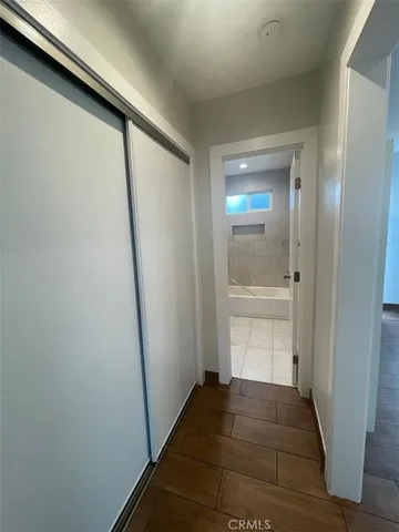 a view of a hallway with wooden floor and staircase