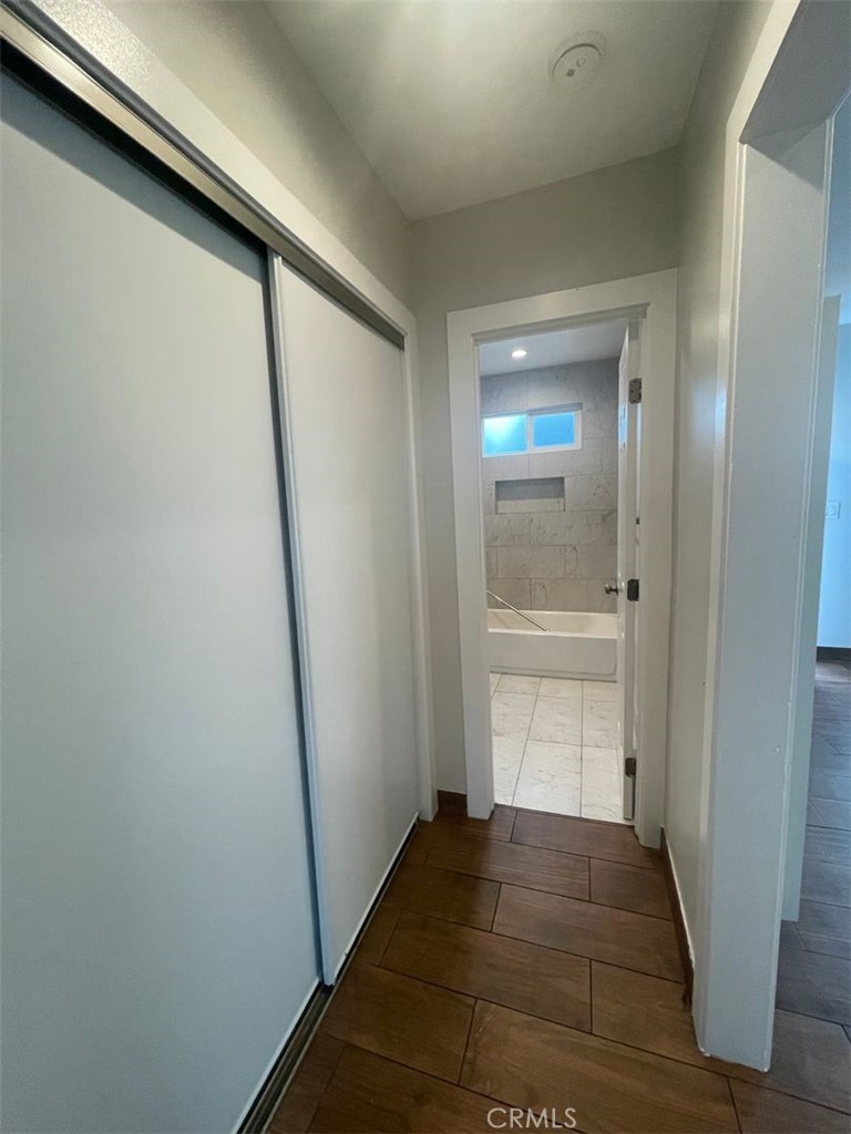 1413 East 53rd Street Los Angeles, CA 90011 - Photo 5 of 11 a view of a hallway with wooden floor and staircase