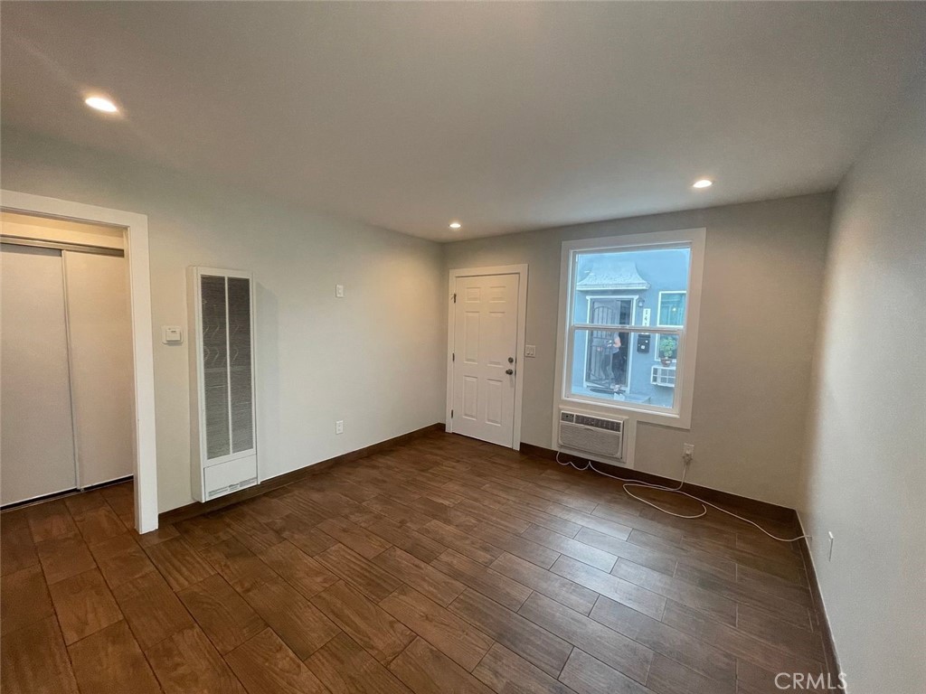 1413 East 53rd Street Los Angeles, CA 90011 - Photo 10 of 11 an empty room with wooden floor and windows