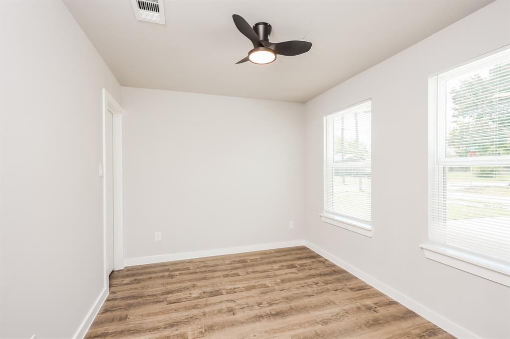 2025 Stuart Street, Unit A Greenville, TX 75401 - Photo 8 of 11 a view of a livingroom with a window and a ceiling fan