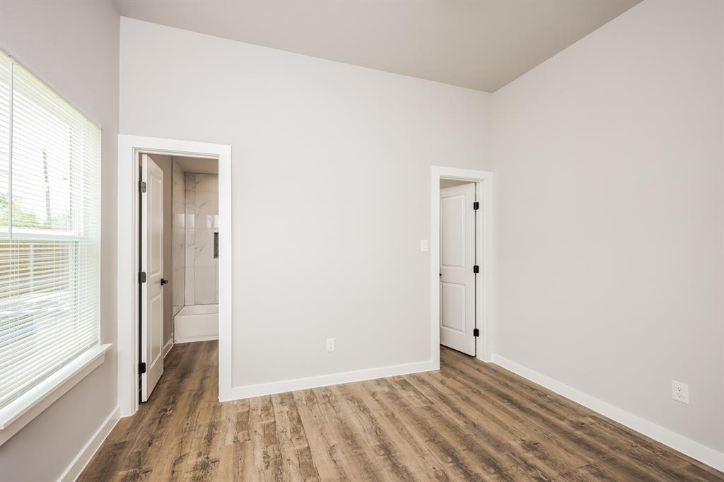 2025 Stuart Street, Unit A Greenville, TX 75401 - Photo 9 of 11 a view of a room with wooden floor and a bathroom