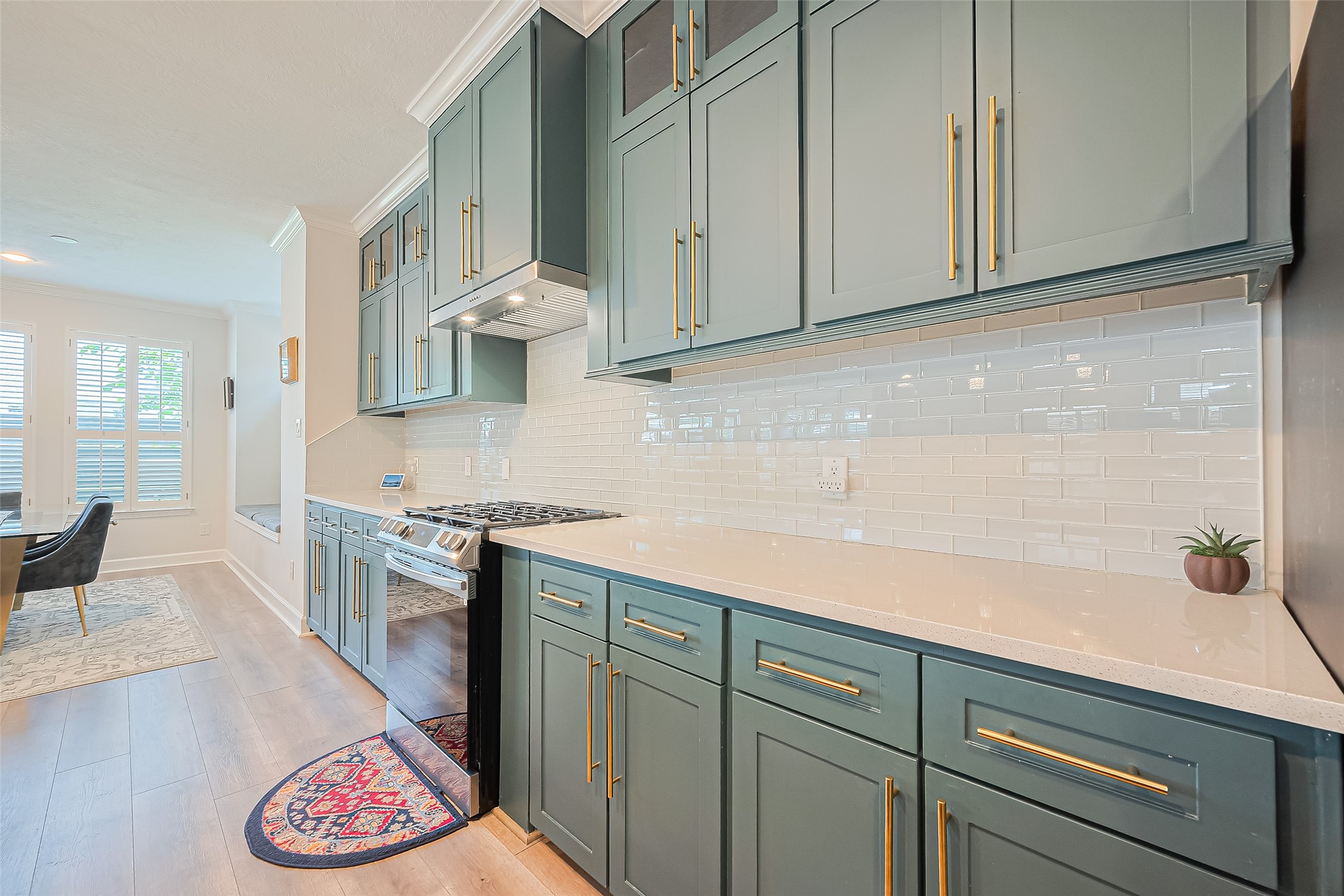 1413 Whispering Pines Drive, Unit 5 Houston, TX 77055 - Photo 11 of 47 a kitchen with stainless steel appliances granite countertop a sink and cabinets with wooden floor