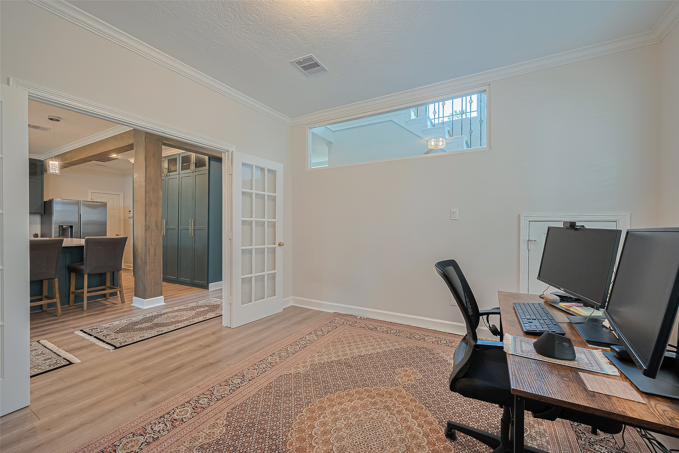 1413 Whispering Pines Drive, Unit 5 Houston, TX 77055 - Photo 17 of 47 a view of a workspace with furniture and wooden floor