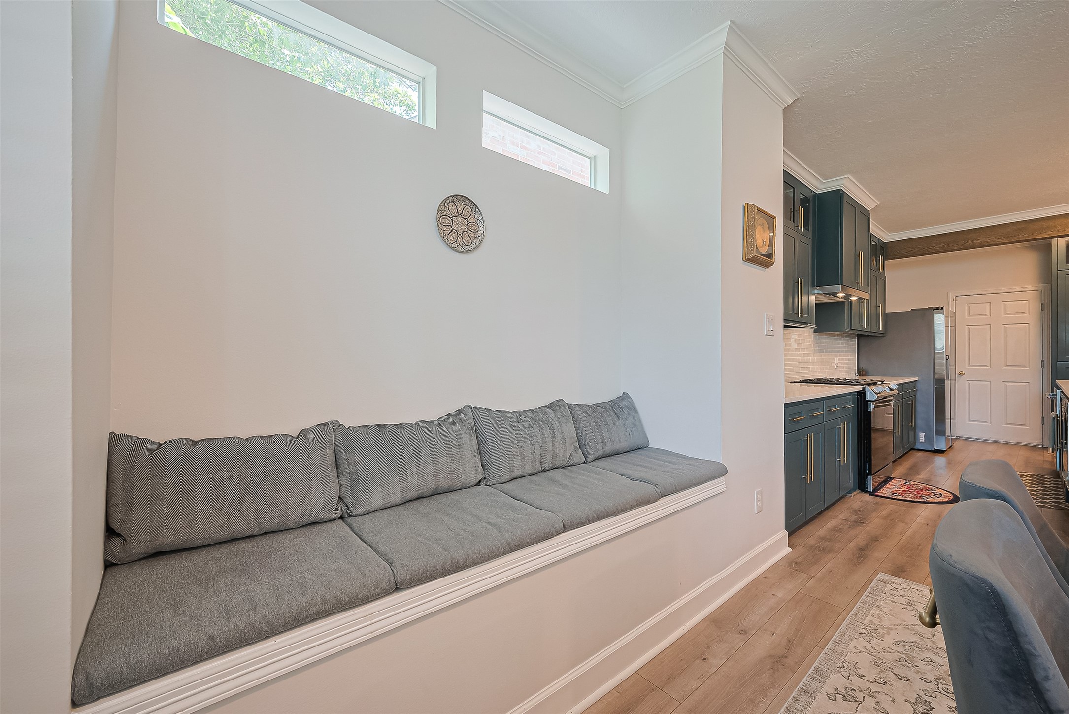 1413 Whispering Pines Drive, Unit 5 Houston, TX 77055 - Photo 21 of 47 a living room with couches and kitchen view with wooden floor