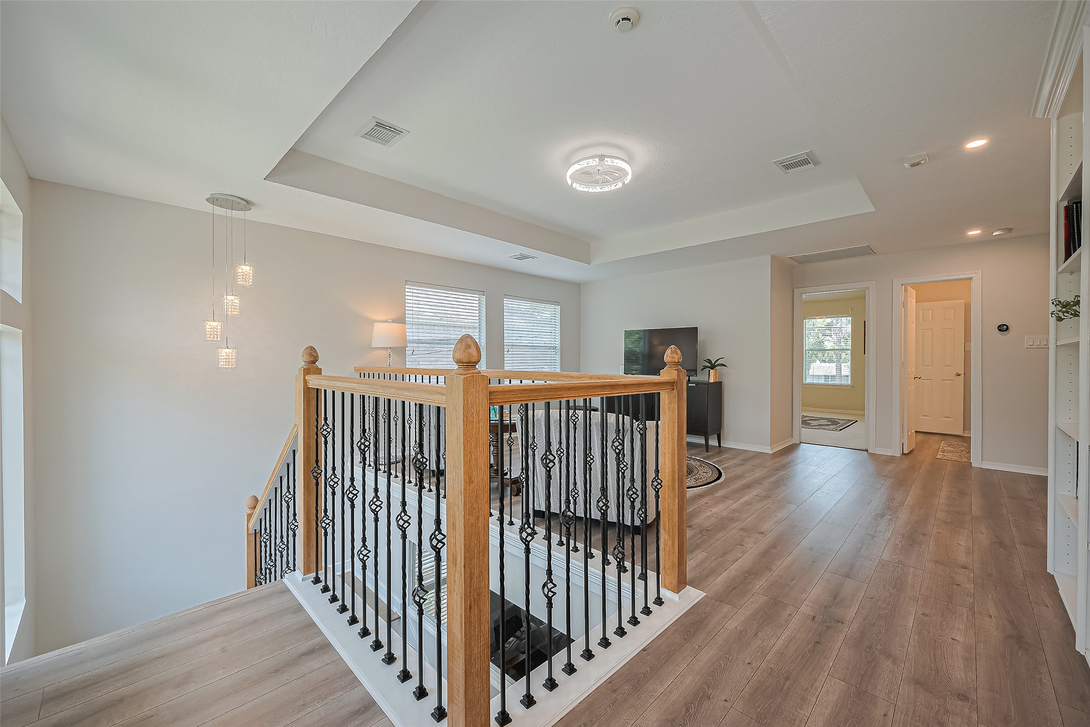 1413 Whispering Pines Drive, Unit 5 Houston, TX 77055 - Photo 25 of 47 a view of a hallway with wooden floor and windows
