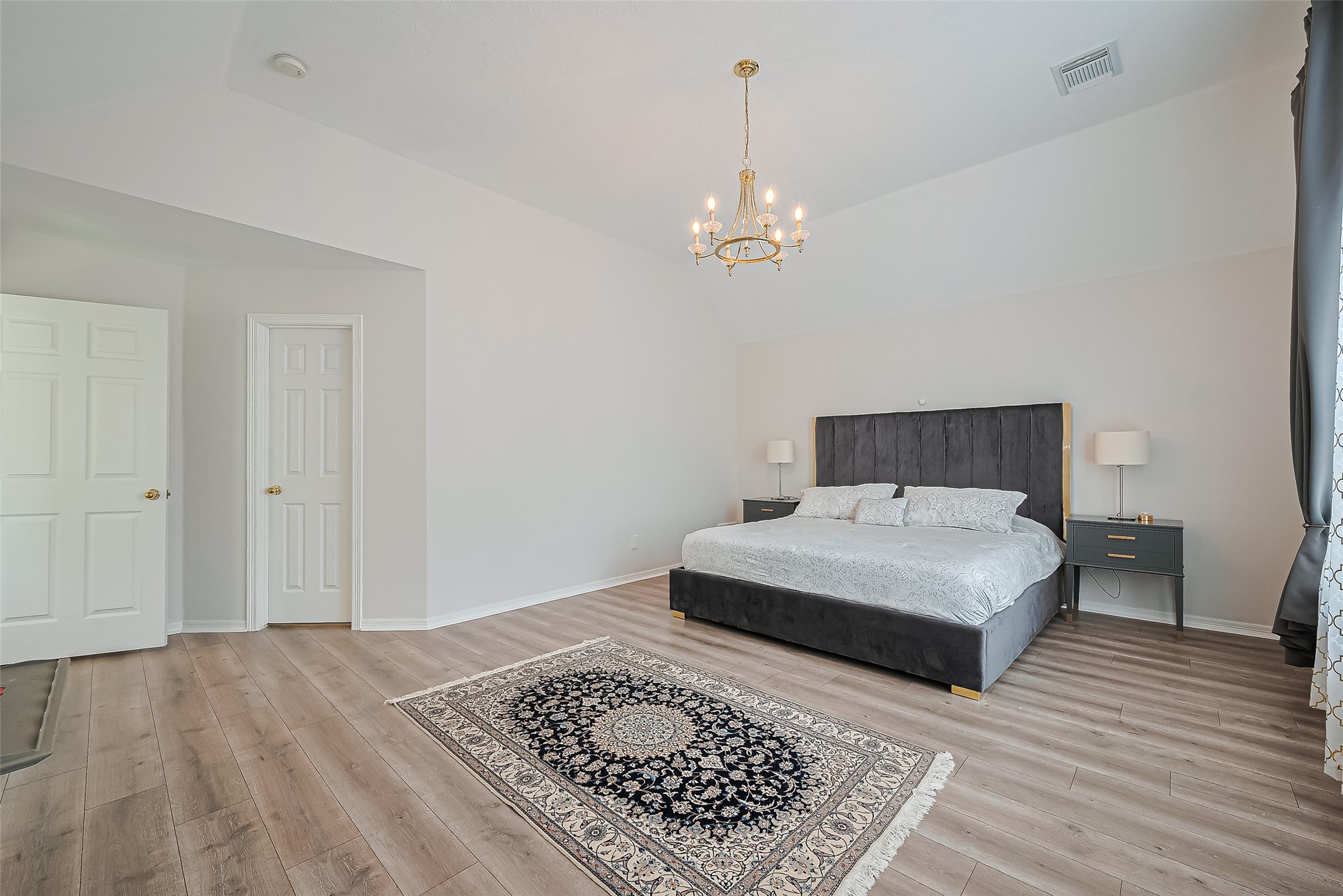 1413 Whispering Pines Drive, Unit 5 Houston, TX 77055 - Photo 31 of 47 a bedroom with a bed and wooden floor