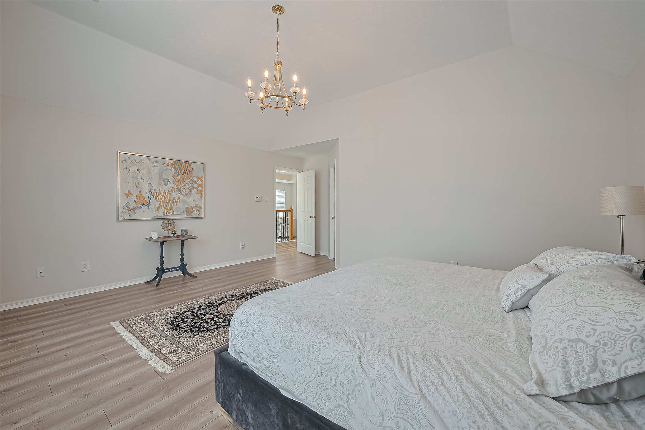 1413 Whispering Pines Drive, Unit 5 Houston, TX 77055 - Photo 32 of 47 a bedroom with a bed and a chandelier