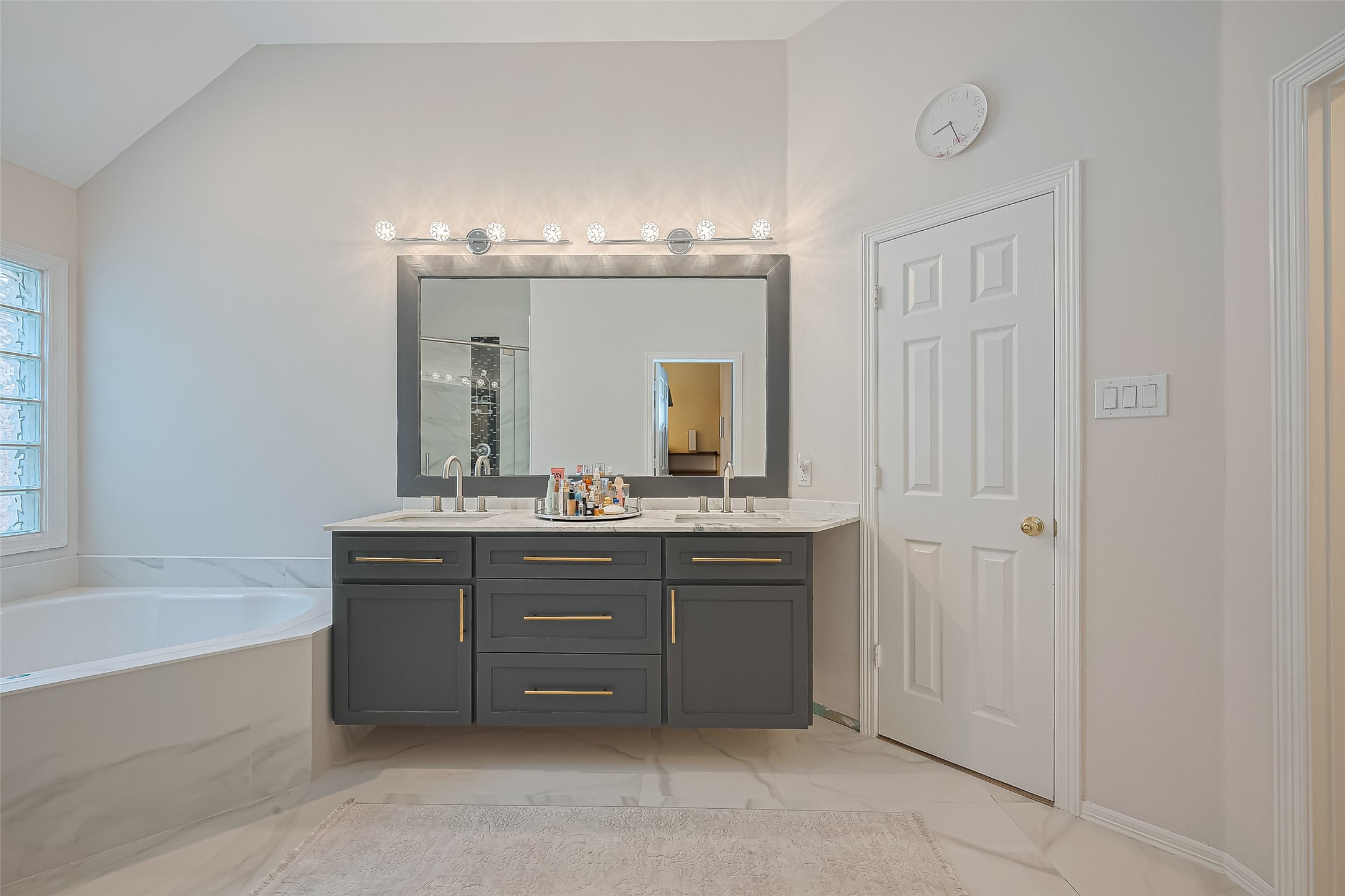 1413 Whispering Pines Drive, Unit 5 Houston, TX 77055 - Photo 33 of 47 a bathroom with a tub sink and mirror