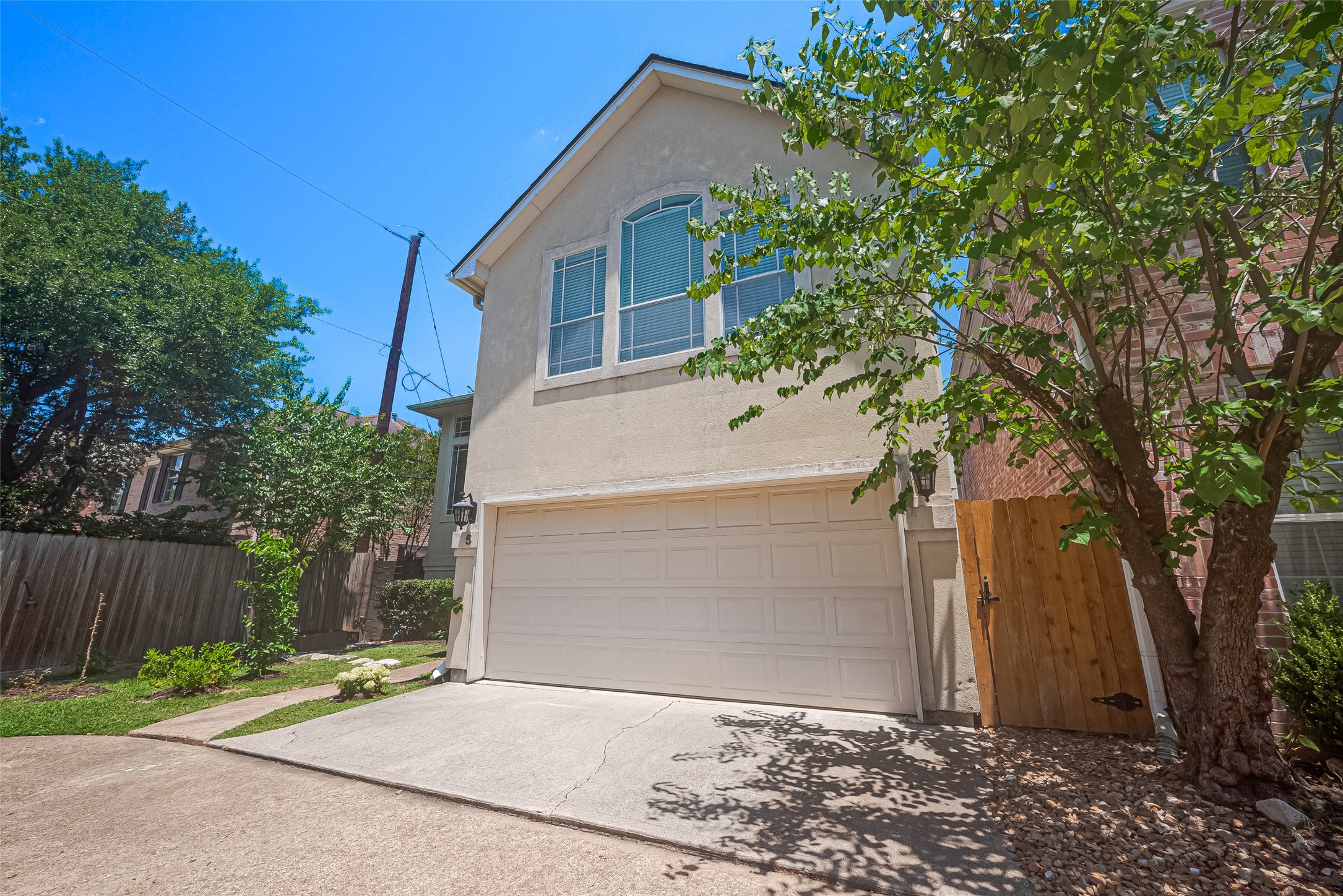 1413 Whispering Pines Drive, Unit 5 Houston, TX 77055 - Photo 6 of 47 a white house with tree in front of it