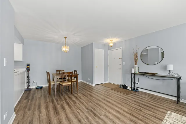 a view of a dining room with furniture and a chandelier