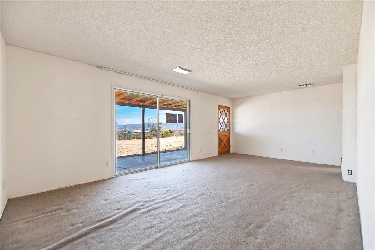 61313 El Coyote Lane Joshua Tree, CA 92252 - Photo 12 of 48 a view of an empty room with a window